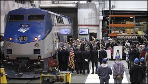 Illinois Gov. Pat Quinn and U.S. Sen. Dick Durbin are joined by state and local officials as they announce the next phase of high-speed rail construction during a news conference at an Amtrak maintenance building in Chicago.