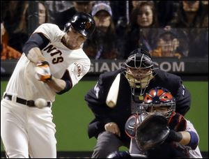 San Francisco Giants' Brandon Belt breaks his bat as he hits a single during the eighth inning of Game 6 of baseball's National League championship series against the St. Louis Cardinals on Sunday.