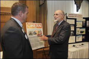 Roger Shope of Bowling Green, a TMACOG member and member of the Ohio Higher Education Rail Network, left, speaks with Thomas C. Carper, chair-man of the board, before the forum at the Toledo Club.