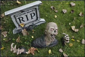 A Halloween display in a front yard of a residence during the windy weather in Pembroke, N.Y. But Despite warnings about tainted candy, candle fires and even child abductions, real Halloween headlines are rarely about any of those things.