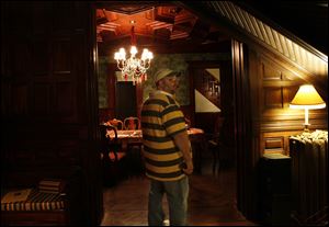 Kirk Baird looks under the stairway as he investigates Mansion View Inn.