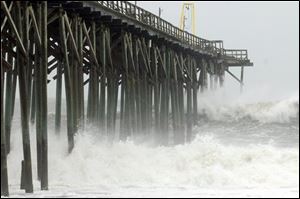 Waves pound Carolina Beach pier in Carolina Beach, N.C., Saturday as Hurricane Sandy churns in the Atlantic Ocean. 