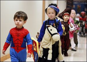 Zander Napierala, 3, left, and Jonathan Rosche, 4, participate in the preschool Halloween celebration Tuesday at Olivet Christian Nursery School in Sylvania.