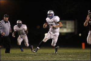 Matt Yoho, of the Bishop Ready Knights, runs the ball during the second quarter of their Division IV playoff game against the Genoa Comets at Genoa High School on Friday.