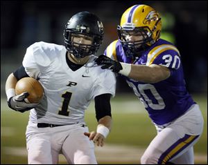 Perrysburg QB Steve Slocum (1) runs the ball against  Avon's Cory Ohradzansky (30) during a Division II high school football playoff game Friday.