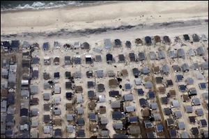 Sand covers the roads where several homes were destroyed or severely damaged by Superstorm Sandy in an area of Seaside Heights, N.J., where the reality show 'Jersey Shore' was filmed.