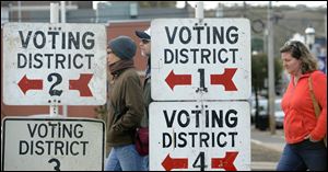 Residents in Atlantic Highlands walk to the Atlantic Highlands Emergency Services Building in New Jersey to vote today as power outages from Superstorm Sandy forced the town to condense all the districts into one location.