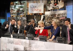 From left, ABC News' Chris Cuomo, actor Tony Danza, actor Andre Braugher, Barbara Walters, Cynthia McFadden and David Novarro manning phones to take donations for victims of Hurricane Sandy during 'Good Morning America' Monday.