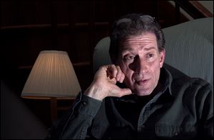 Dr. Tim Reichard speaks about his recent fi ring from the Toledo Zoo in his South Toledo home. Dr. Reichard was dismissed from his veterinary post on Feb. 28 after 22 years of service.