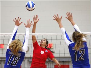 Owens Community College's Dominique Yates (8), a Bowsher graduate, tips the ball over the net against Kirkwood. The Express will play in the national semifinals today. 