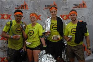 From left, teammates Dioni Gomez, Ashley Sepanski, Zach Barton and Justin Weber after the Tough Mudder race. 
