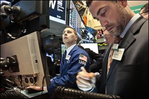Joseph Mastrolia, left, a trader with Barclays, and Chris Casaliggi, Euronext floor manager, begin early trading on the floor of the New York Stock Exchange.