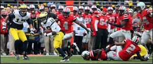 Michigan's Denard Robinson breaks away for a 68-yard touchdown run.
