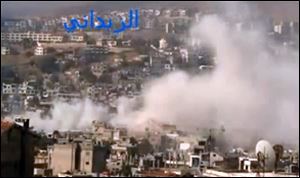 In this image taken from video obtained from the Shaam News Network, smoke rises from buildings due to government shelling in the Damascus suburb of Zabadani, Syria, on Friday.