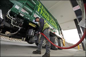 Waste Management driver Alan Sadler fills his truck with CNG gas at the company's filling station in Washington, Pa. Years from now, motorists needing a fill-up might see natural gas pumps sharing space at the neighborhood filling station with ones dispensing gasoline and diesel.