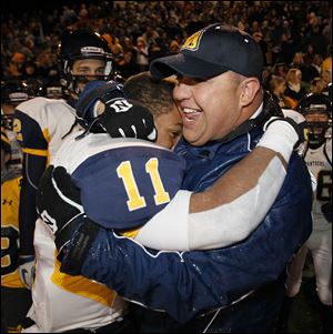Whitmer's Me'Gail Frisch hugs head coach Jerry Bell after the Panthers defeated Mentor to advance to the state final.