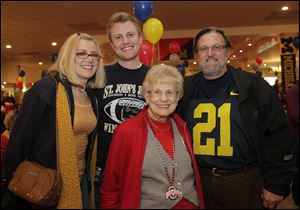From Left: Barb Mann, Billy Mann, the event co-ordinator, with his grandmother Rita Pletcher and father, Rick Mann. The Border Battle Bash to benefit the Boys & Girls Clubs of Toledo: 19th annual celebration of the OSU/UM Rivalry, held in Maumee.