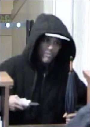 This surveillance photo from the Huntington bank at Madison and Huron streets shows the suspect in Tuesday's robbery.