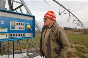 Chuck Phillips, co-owner of Phillips & Son Irrigation Services in Bristol, Ind., shows a control panel at a pivot point on a three-span irrigation system. The company is busy installing and expanding the equipment throughout the region. Business has doubled this year, Mr. Phillips said.