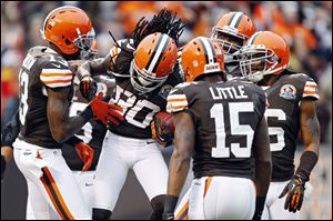 Cleveland Browns wide receiver Travis Benjamin (80) is congratulated by teammates after a 93-yard punt return for a touchdown in the second quarter of Sunday's against the Kansas City Chiefs in Cleveland.