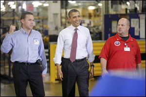 President Barack Obama walks with Plant Manager and Vice President of Operations Jeff Allen, left, and UAW NW Local 163 Detroit Diesel Engine Unit Shop Chairperson Mark 