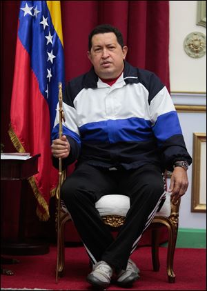 Venezuela's President Hugo Chavez holds a sword that once belonged to independence hero Simon Bolivar at a meeting with his Cabinet, at Miraflores Presidential palace in Caracas, today.