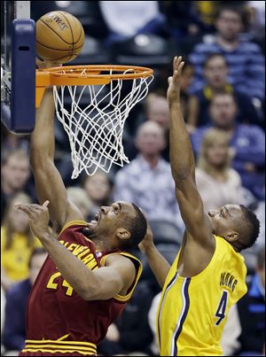 Cleveland Cavaliers' Samardo Samuels puts up a shot against Indiana Pacers' Sam Young on Wednesday in Indianapolis.