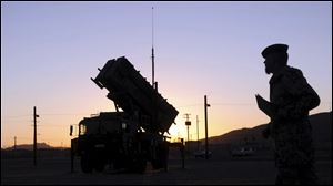 A German soldier stands next a Patriot surface-to-air missile battery on the training ground of the German Bundeswehr,  in Fort Bliss near El Paso, Texas, USA. 