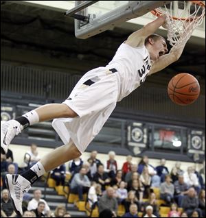Perrysburg's Shane Edwards, who scored 33 points, dunks the ball against Napoleon in Thursday night's Northern Lakes League game.