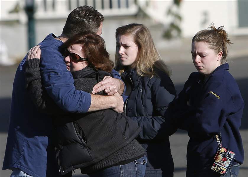 Mourners-embrace-outside-Saint-Rose