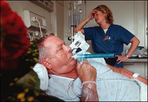 Gary Renwand uses an inhaler at St. Charles Mercy Hospital. He contracted beryllium disease at Brush's Elmore plant, where he helped produce beryllium for U.S. weapons. Records show he was repeatedly exposed to levels of beryllium dust five times the safety limit. He says: 