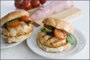 In this undated image, chopped turkey tenderloin makes a lean and delicious burger, especially when spiked with smoked paprika and prosciutto, and served with manchego cheese in Concord, N.H. (AP Photo/Matthew Mead)