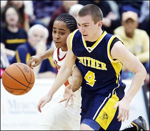 Whitmer's Luke Hickey (4) and Central Catholic's D.J. Moody chase a loose ball during their TRAC game Friday. Whitmer won 39-30.