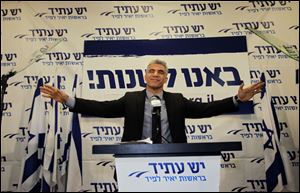 Yair Lapid gestures as he delivers a speech at  his 