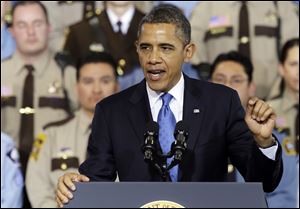 President Barack Obama gestures while speaking today to outline his plan on gun violence at the Minneapolis Police Department's Special Operations Center in Minneapolis. 
