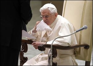 Pope Benedict XVI wipes his face after drinking during his weekly general audience at the Paul VI Hall at the Vatican, today. Looking tired but serene, Pope Benedict XVI told thousands of faithful that he was stepping down for 