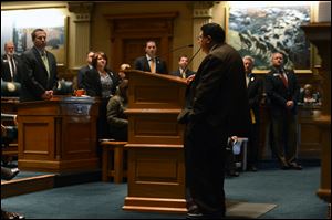 Supporters for Rep. Edward Vigil, D-Fort Garland, stand as he explains why he will be voting against his party and the four gun control bills before the Colorado House at the State Capitol in Denver.
