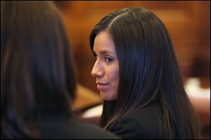 Alexis Wright, 29, turns towards her attorney Sarah Churchill, left, during her arraignment in Portland, Maine.