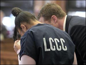 Kenisha Pruitt, with her attorney, James Anderson, struggles to give details on how she murdered her son. Pruitt pleaded guilty in Lucas County Common Pleas Court to a charge of aggravated murder in the death of her newborn son. 
