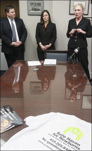 Lucas County assistant prosecutors Robert Miller, left,  and Lindsay Navarre, and county Prosecutor Julia Bates remind the public of Ohio's Safe Haven Law that allows newborns to be left in the care of police, firefighters, or a hospital without questions.