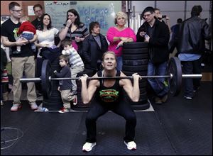 Temperance, Mich. resident Theresa Crawford thrusts 95 pounds.