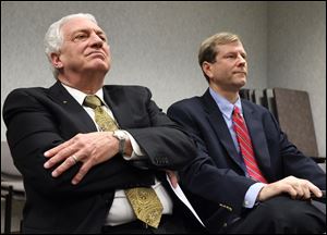 Democratic party chairman Ron Rothenbuhler, left, and Republican party chairman Jon Stainbrook, both members of the Lucas County Board of Elections, listen as Mr. Ruvolo and Mr. Allison  recommend the removal of the director and deputy director of the Board of Elections. 