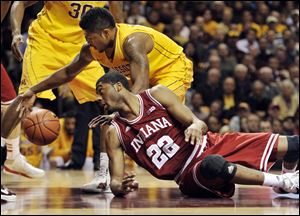 Minnesota's Maverick Ahanmisi, top, and Indiana's Maurice Creek (22) go for a loose ball during the first half tonightin Minneapolis.