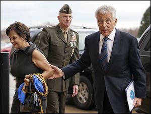 Marine Corp. Lt. Gen. Tom Waldheuser, center, greets Sen. Chuck Hagel, (R., Neb.), right, and his wife Lilibet, as they arrive at the Pentagon to be sworn-in as Secretary of Defense.