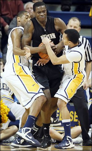 UT's Matt Smith, left, and Josh Lemons battle Western Michigan's Darius Paul in Wednesday night's game at Savage Arena. Paul led all scorers with 28 points.