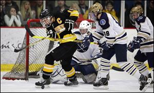 Sylvania Northview's Zander Pryor (19) moves the puck against  St. John's goalie Mike Barrett (29).
