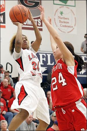Rogers' Cha'Ron Sweeney prepares to score over Port Clinton's Paige Culver during the second half. Sweeney led the Rams with 24 points.