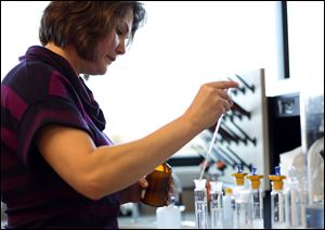 Research scientist Maria Yost works to create alcoholic beverages at Beam Inc.’s Global Innovation Center in Clermont, Ky.