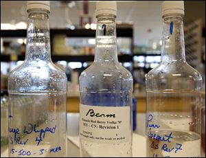 Test samples sit in Beam’s product development lab. Analysts say the recent flavor experimentation with bourbon and tequila is bolstering consumption.