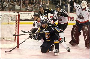 Toledo's Nino Musitelli (7) is pushed away from the goal after scoring his second goal of the game.
